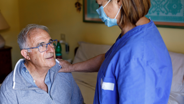 nurse looking after elderly gentleman at home