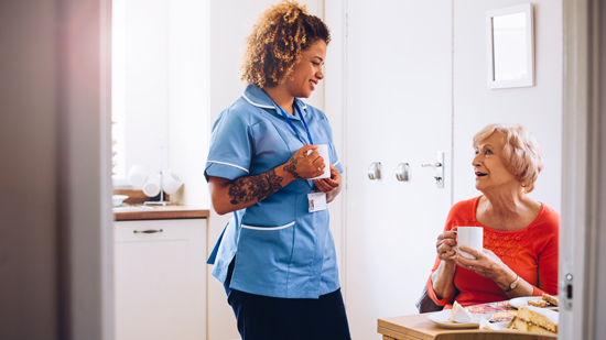 nurse taking tea and cake break with client